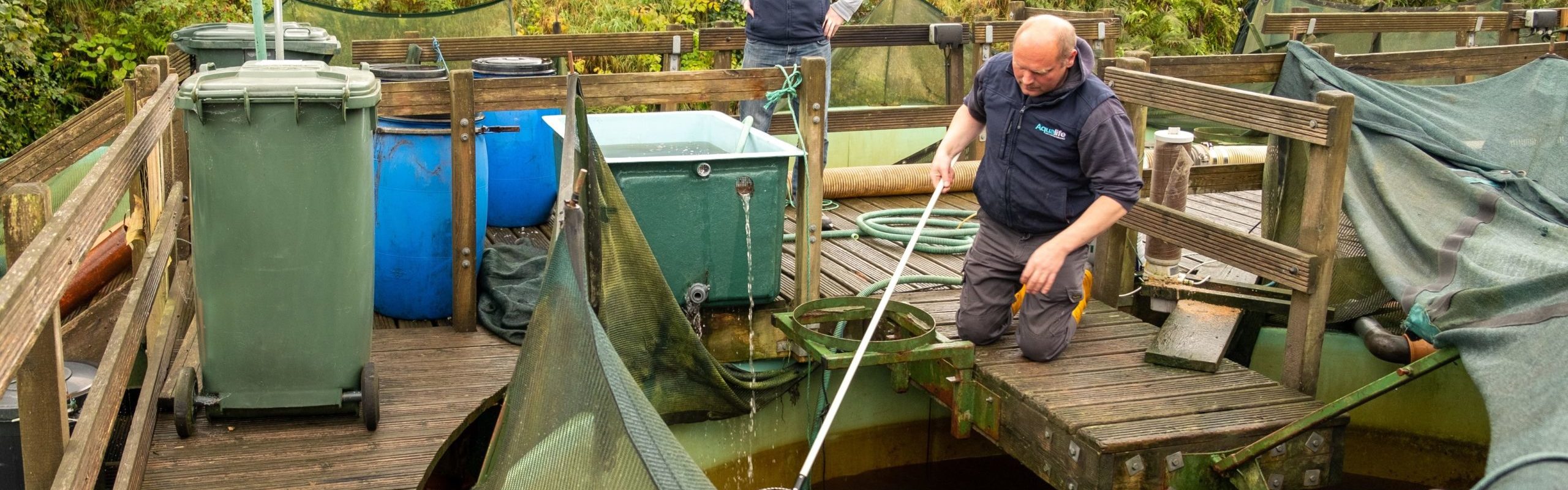 Aqualife Team members outside collecting a fish sample